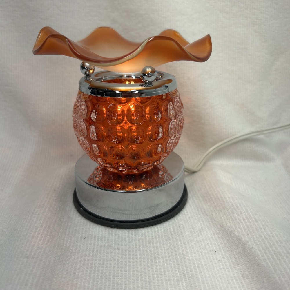 Orange electric oil/wax fragrance warmer with touch technology.